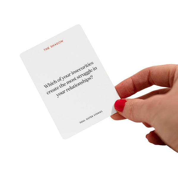 Hand holding a card. Text on card says Which of your insecurities create the most struggle in your relatiionships?